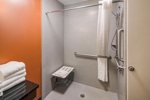 a small bathroom with a shower with towels at Sleep Inn & Suites Hurricane Zion Park Area in Hurricane