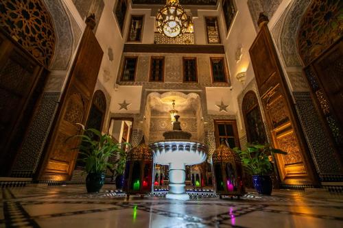 a large room with a large clock in a building at Riad Sidrat Fes in Fès