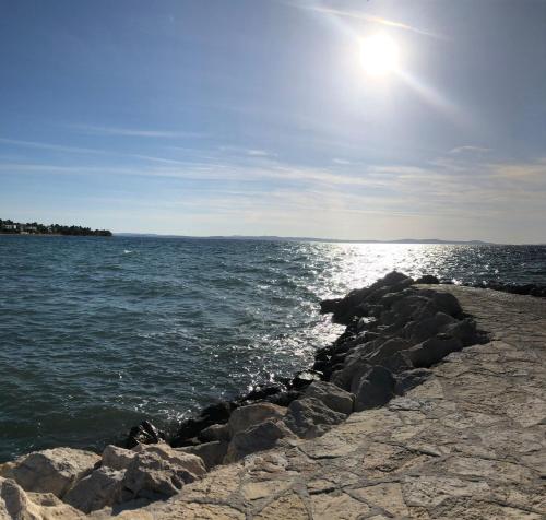 a group of rocks on the shore of a body of water at Apartman Lili in Zaton