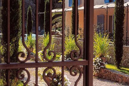 a gate with a bunch of plants in a garden at La Bastide de Valbonne in Valbonne