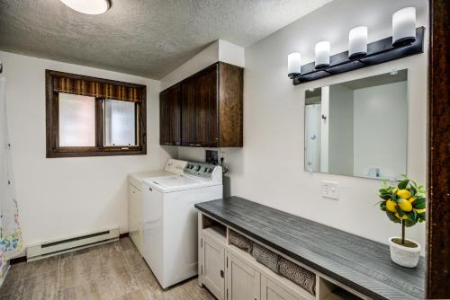 a kitchen with a washer and dryer in a room at Geyser Getaway in West Yellowstone