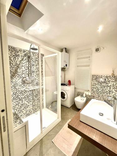 a bathroom with a shower and a sink and a toilet at Relax Suite Holiday Apartment CIN IT02215CPAJVF in Riva del Garda