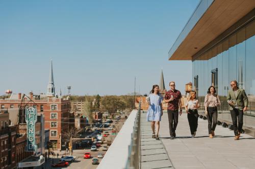 a group of people walking down a sidewalk on a building at Jasper Hotel in Fargo
