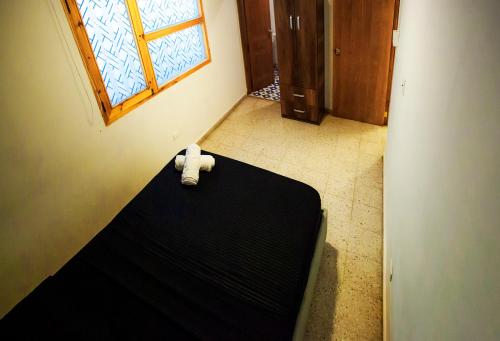 Postel nebo postele na pokoji v ubytování Hostal El Bando