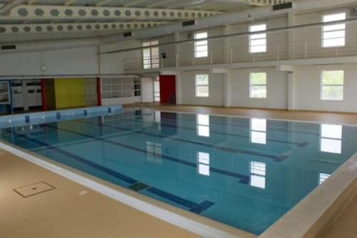 a large swimming pool in a large room at Anjú-Pardal in Mogadouro