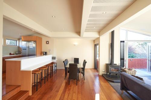 a kitchen and living room with a bar and a couch at Kaltech House - Lake Tekapo in Lake Tekapo