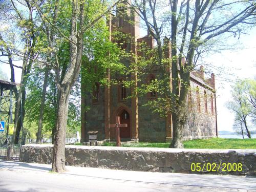 an old stone building with trees in front of it at Stary Drahim in Czaplinek