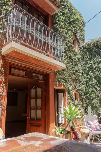 a building with a balcony and a door at Hotel Casa Pereyra in Oaxaca City