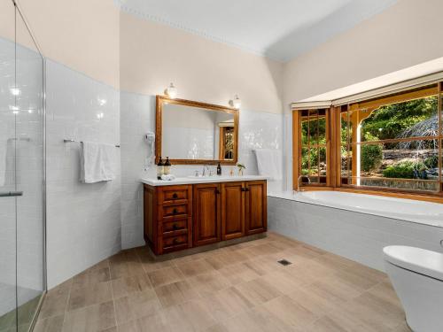 a bathroom with a sink and a mirror at Tiverton in Kurrajong