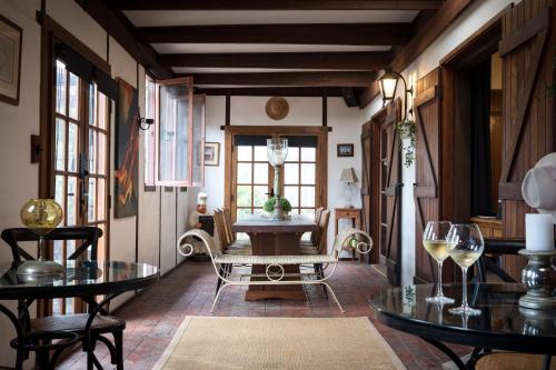 a room with tables and chairs and a table with wine glasses at The Table Guest House in Greta