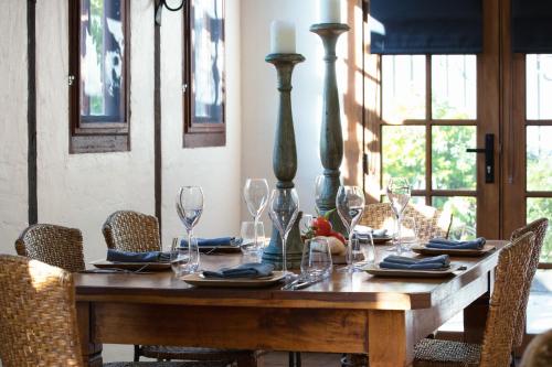 a wooden table with plates and glasses on it at The Table Guest House in Greta