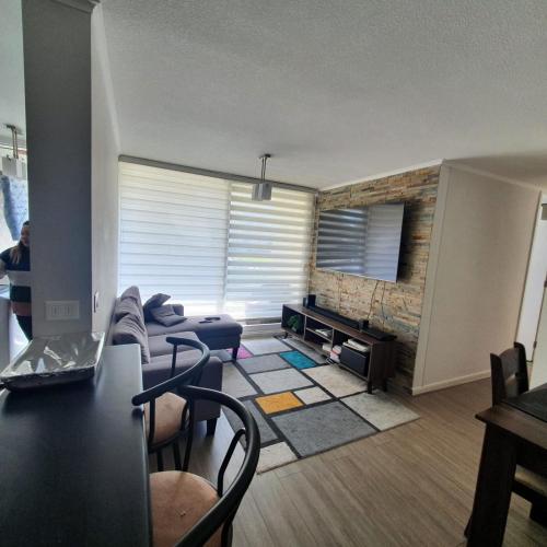 a living room with a couch and a table at DEPARTAMENTO EL OASIS in La Serena