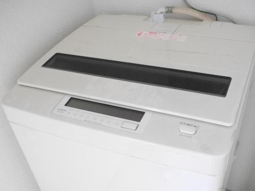 a white printer sitting on top of a white machine at Station Business Hotel Tenshukaku in Hitoyoshi
