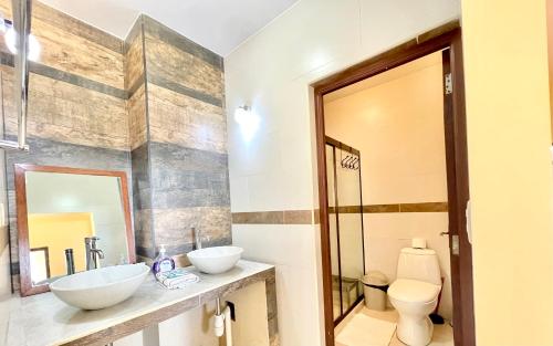 a bathroom with two sinks and a toilet at Apartment with beautiful landscape in Sucre
