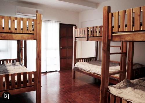 a bedroom with three bunk beds in a room at BAAN64 Hostel in Hat Yai