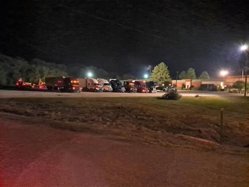 a group of cars parked in a parking lot at night at Super 8 by Wyndham Atoka in Atoka