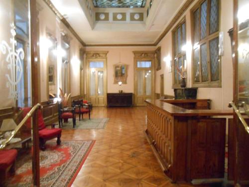 a large room with a table and chairs at Hotel Reina in Buenos Aires