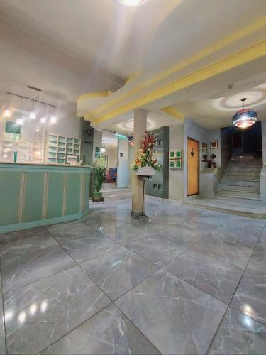 a lobby of a building with a staircase and a lobby at Hotel Villa Valpovo in Valpovo