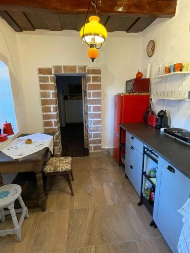 a kitchen with a table and a small table and a dining room at Róza Vendégház in Buják