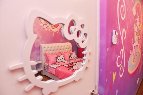 a small childs bedroom with a hello kitty bed at Play at HELLO KITTY Kawaii Fun House in Kuala Lumpur