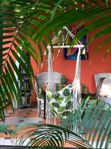 a room with two chairs and a plant at Arco Iris Boutique Hotel & Restaurant in Candidasa