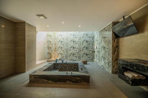 a large bathroom with a tub and a tv at Feng Cai Motel in Yuanlin
