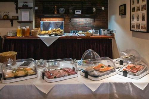 a table with several trays of food on it at Villa Altstadtperle Erfurt in Erfurt