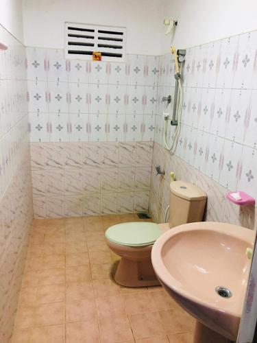 a bathroom with a toilet and a sink at Bathiya Tourist Guest Anuradhapura in Anuradhapura