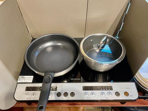 two pans sitting on top of a scale at Hotel EL Shinjuku 6 in Tokyo