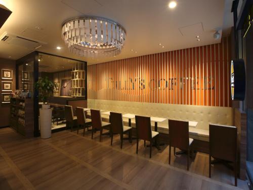 a dining room with a long table and chairs at remm Kagoshima in Kagoshima