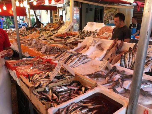 a market with many different types of fish on display at La Dimora del Massimo in Palermo