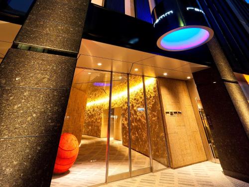 a lobby of a building with a blue light at remm Kagoshima in Kagoshima