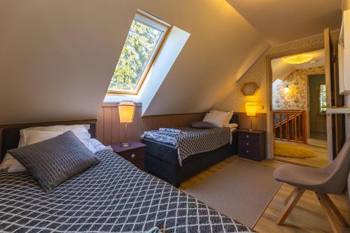 a attic bedroom with a bed and a window at Nuutri Villa in Kärdla