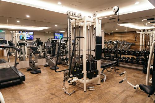 a gym with several treadmills and cardio machines at Gorski Hotel & Spa in Kopaonik