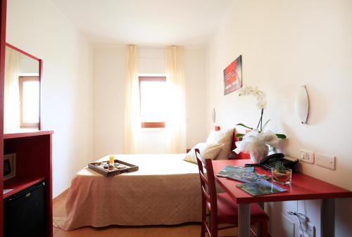 Ένα ή περισσότερα κρεβάτια σε δωμάτιο στο Hotel Delle More