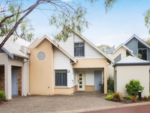 a large white house with a driveway at Cape View Villa- 74 in Broadwater