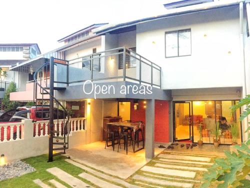 a building with a sign that reads open areas at Alimama Guesthouse Melaka with Balcony in Melaka