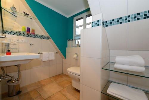 a bathroom with a sink and a toilet at Haus Bornholm Whg 23 in Nieblum