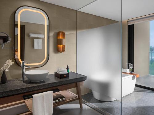 a bathroom with a sink and a mirror at Crowne Plaza Phu Quoc Starbay by IHG in Phu Quoc