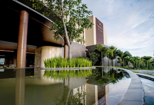 a building with a reflecting pool in front of it at Crowne Plaza Phu Quoc Starbay by IHG in Phu Quoc