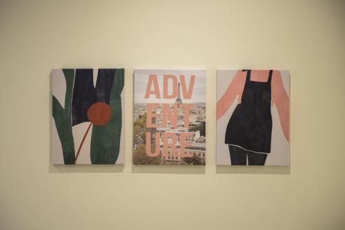 three pieces of art hanging on a wall at Le PALME in Parma