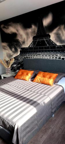a bedroom with a bed with a eiffel tower at La Maison de Marie in Borgloon
