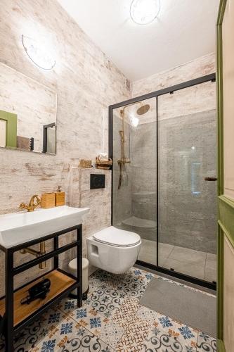 a bathroom with a shower and a toilet and a sink at Penzion Betlém in Hlinsko
