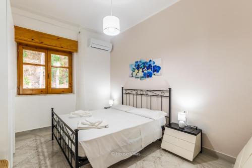 Ένα ή περισσότερα κρεβάτια σε δωμάτιο στο House&Villas - Villa Zagara Bianca