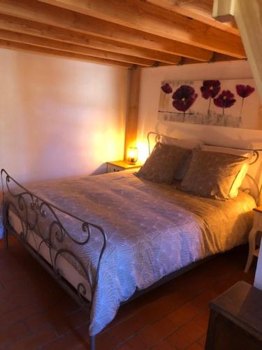 a bedroom with a large bed with flowers on the wall at Gite du Moulin de la Virvée in Saint-André-de-Cubzac