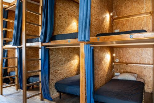 a group of bunk beds in a room at Casa da Mata SurfHouse in Costa da Caparica