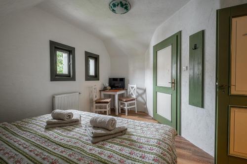 a bedroom with a bed with towels on it at Penzion Betlém in Hlinsko