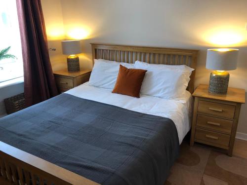 a bedroom with a large bed with two night stands at The Blair Street Residence in Edinburgh