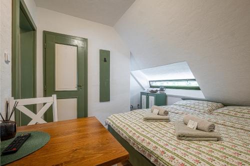 a bedroom with a bed with two pillows on it at Penzion Betlém in Hlinsko