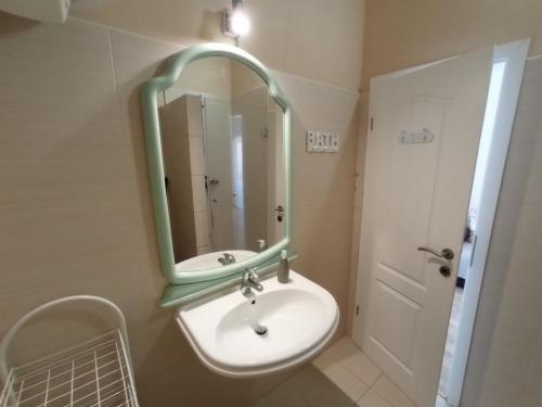 a bathroom with a sink and a mirror at Villa Dobra Holiday Apartments in Vir